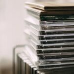 A stack of transparent CD cases neatly aligned, creating a still life composition.